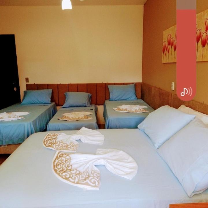 Una cama o camas en una habitación de Pousada Mares de Penha