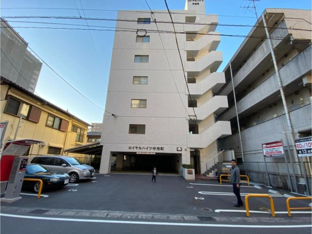 a building with a clock tower in a parking lot at Royal Heights Chuocho - Vacation STAY 12749 in Kagoshima