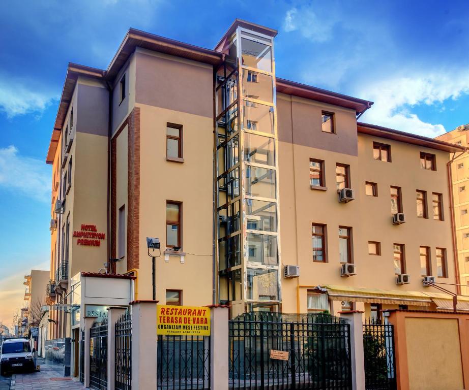 a building with a fence in front of it at Hotel Amphitryon in Bucharest