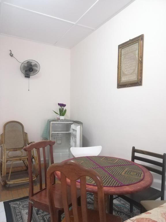 - une salle à manger avec une table et des chaises dans l'établissement Roomstay homestay Ahmad Rompin, à Kuala Rompin