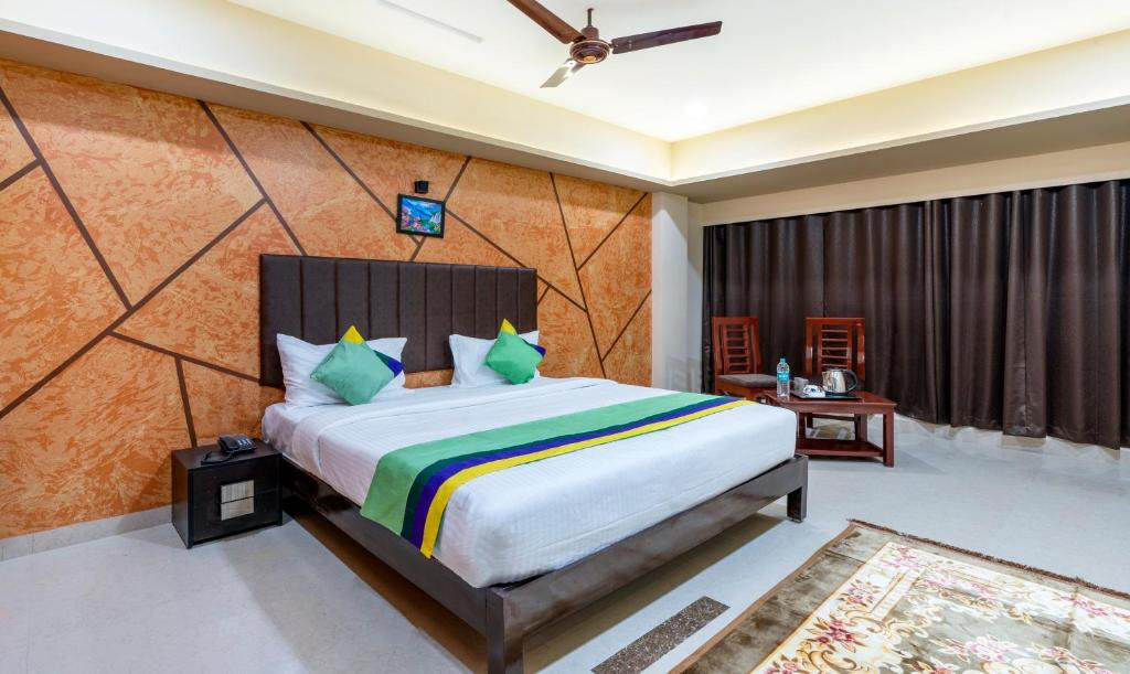 a bedroom with a large bed in a room at Treebo Trend D Grand in Madurai