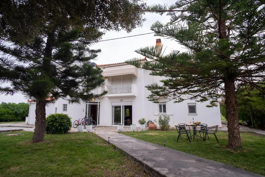 a white house with trees in front of it at Stefano's Home in Potokáki