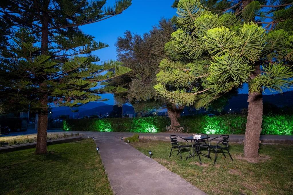 a table and chairs in a park at night at Stefano's Home in Potokáki