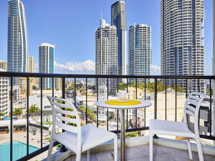 a balcony with a table and chairs and a view of a city at Stay in the heart of Surfers in Gold Coast