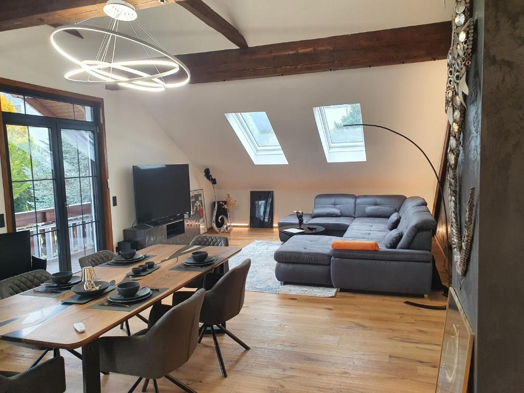 a living room with a table and a couch at Luxury - Loft in Villach