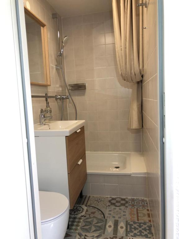 a bathroom with a toilet and a sink and a shower at Pension Trent in Trent