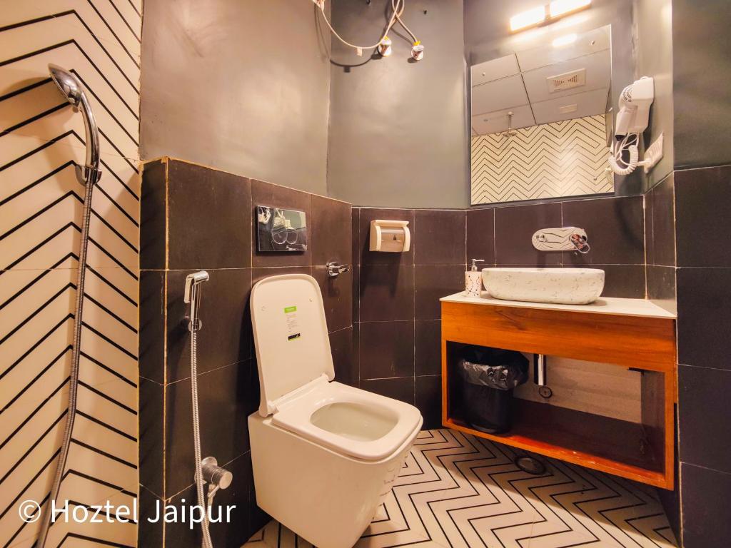 a bathroom with a toilet and a sink at Hoztel Jaipur in Jaipur