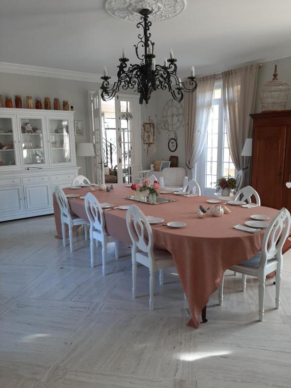 a dining room with a large table and chairs at Maison Coqueréaumont in Montagne