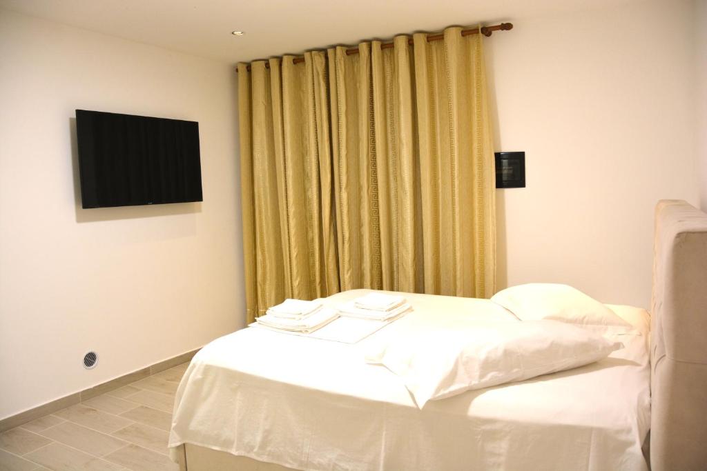 Postel nebo postele na pokoji v ubytování Mico's Apartments