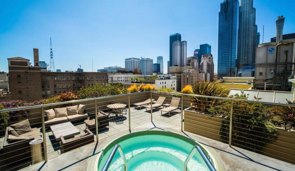 a hot tub on a balcony with a view of the city at Historic Downtown LA Loft - Urban Charm in Los Angeles