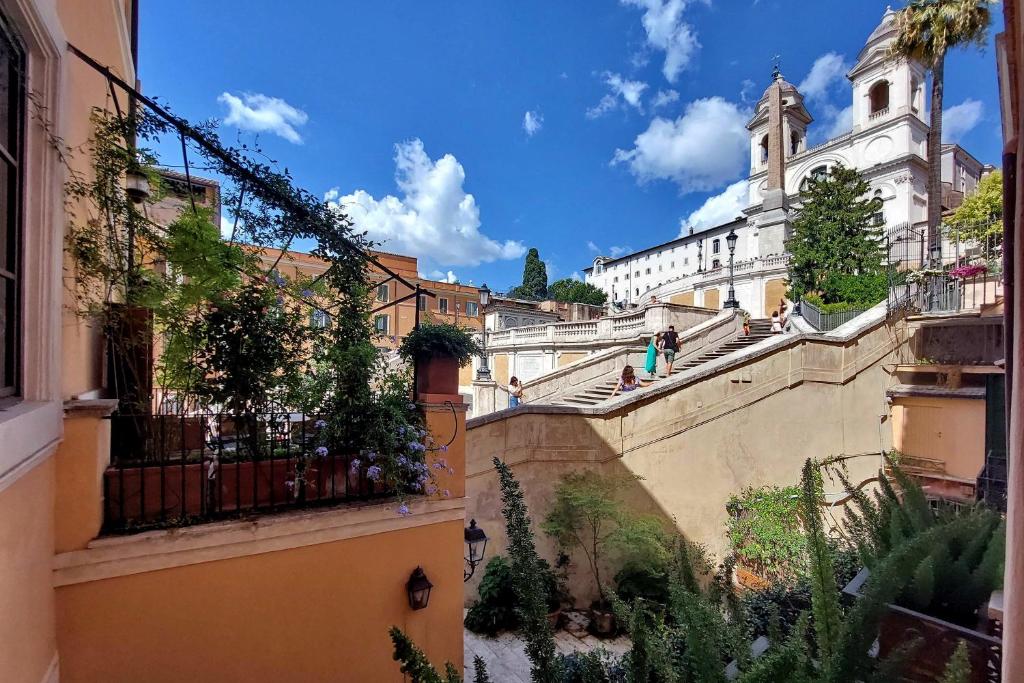 a view of a city with buildings and a church at On The Steps in Rome