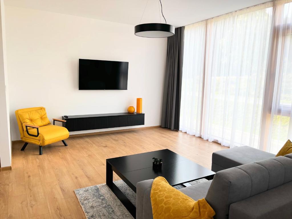 a living room with a couch and a table at Apartmány Kamenec in Zákamenné