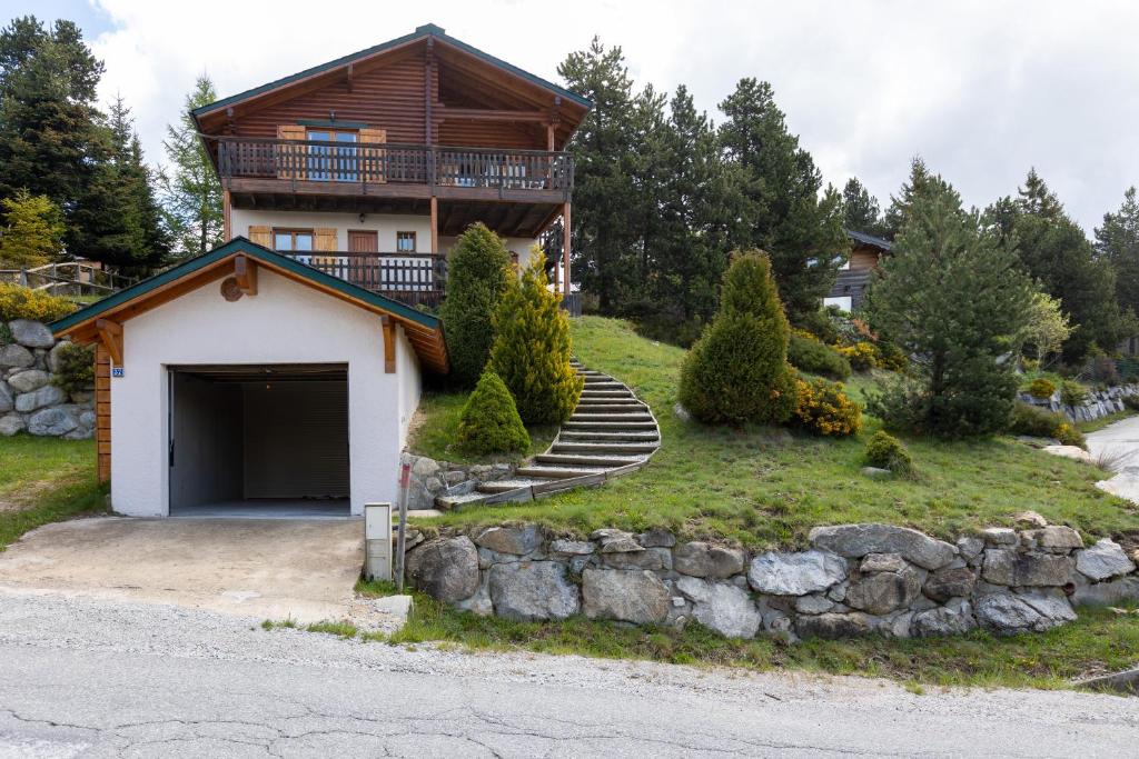 a house on top of a hill with a garage at Chalet les deux marmottes - Vue montagne in Bolquere Pyrenees 2000