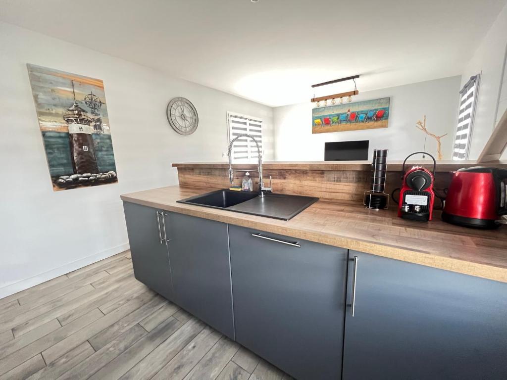 a kitchen with a sink and a counter top at Phare de Chauveau - Maison de Charme à Sainte Marie in Sainte-Marie-de-Ré