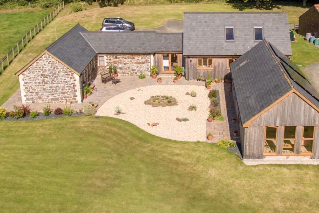 an aerial view of a house with a backyard at Spacious Luxury barn conversion - next to Tarka Trail cycle path in Great Torrington