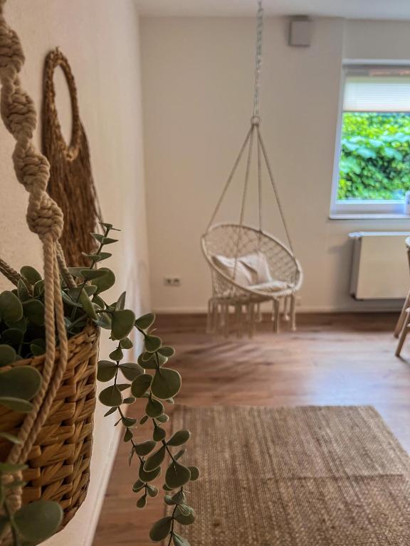 a living room with a swing and a plant at Bergoase Relax&Spa in Unteropfingen