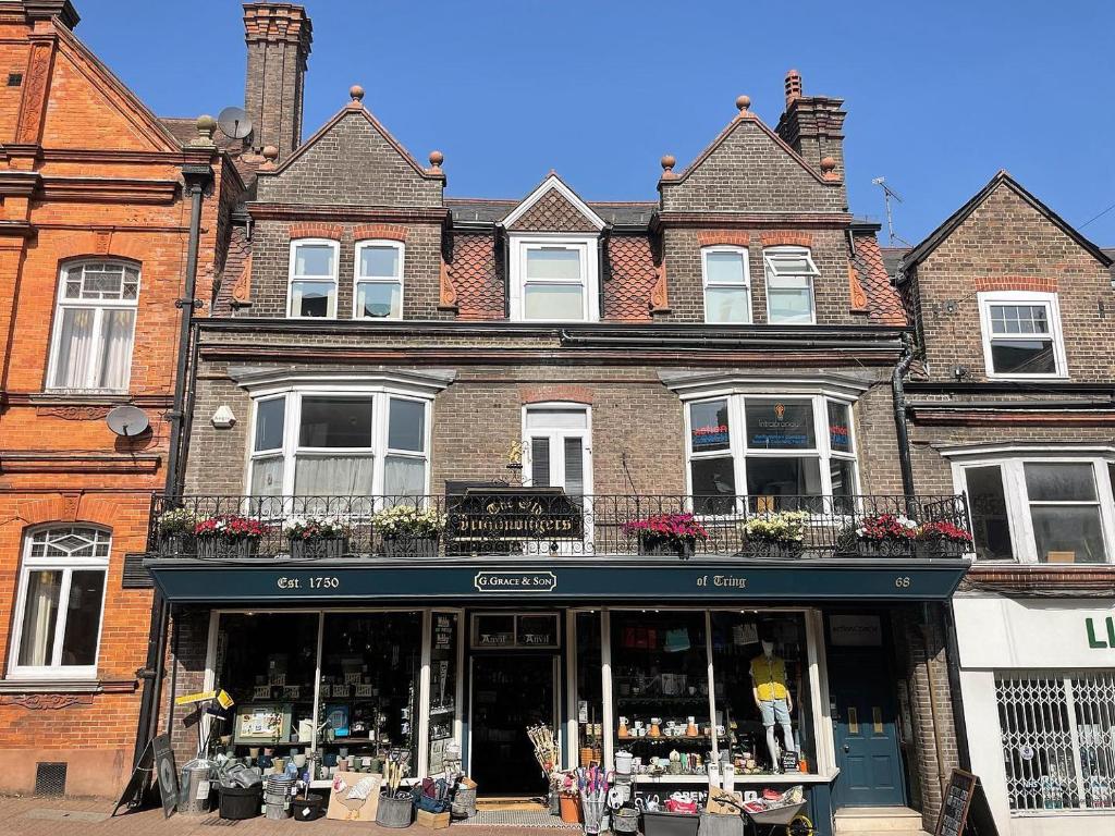 a store in front of a brick building at Large West Side Room above G Grace & Son in Tring
