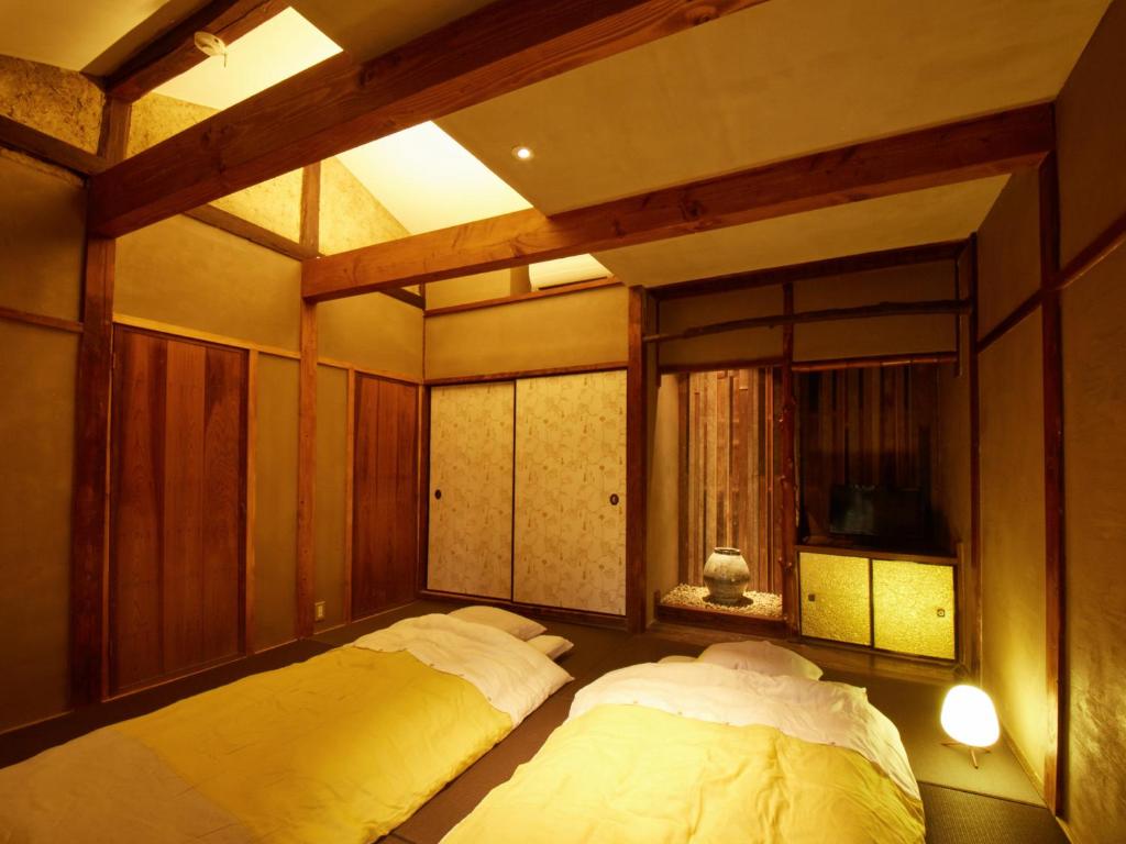 Postel nebo postele na pokoji v ubytování sakainoma hotel 熊