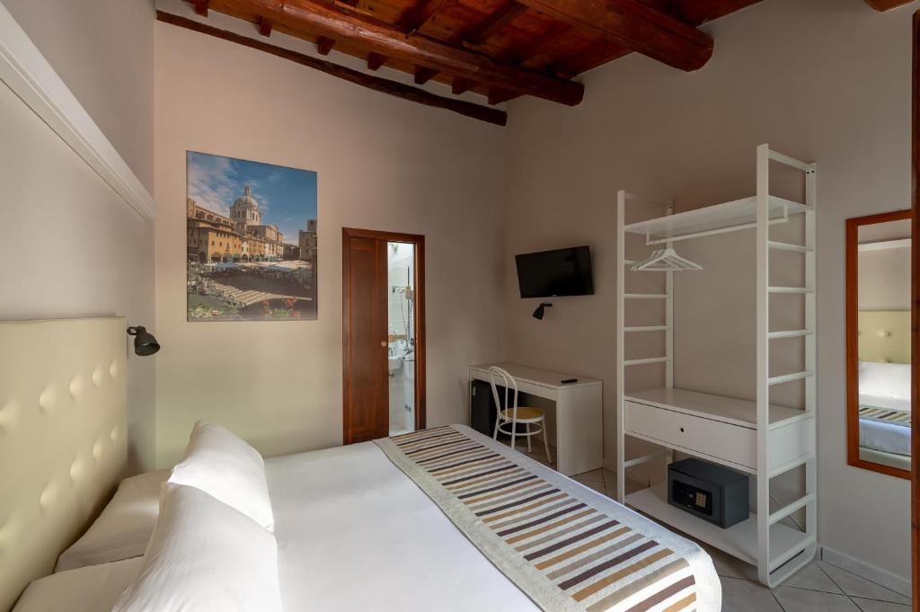 a bedroom with a white bed and a shelf at Abbazia Bed & Breakfast in Mantova