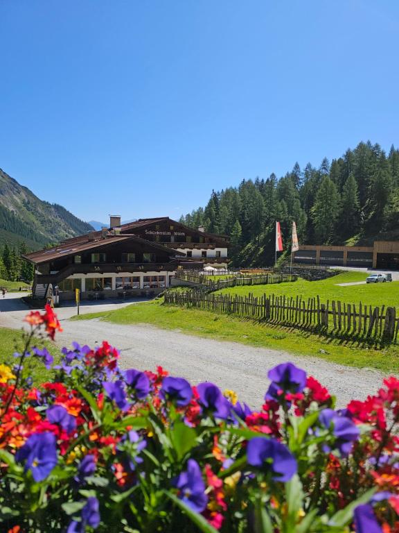 a bunch of flowers in front of a building at Die Schlickeralm in Telfes im Stubai