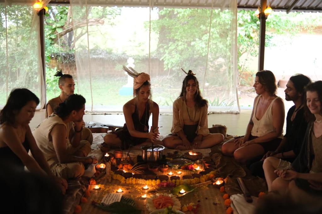a group of people sitting around a table with candles at Villas in Wellness Centre with Sauna in Arambol