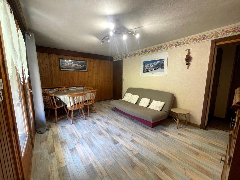 a room with a bed and a table in it at Ty Menez 1 - Appartement sur les pistes in La Clusaz