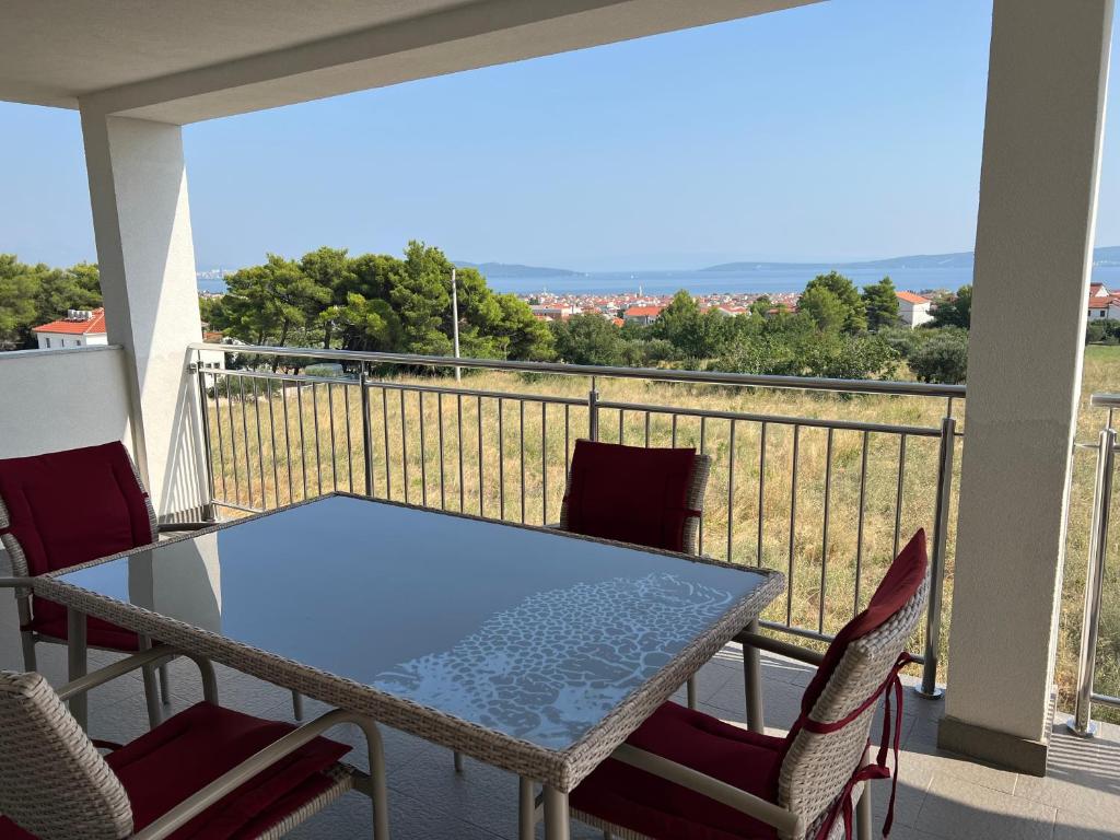 a table and chairs on a balcony with a view at Seaview Apartments Lagetar in Kastel Novi