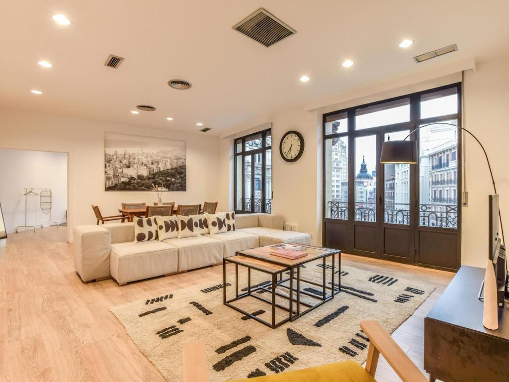 a living room with a couch and a table at apartamento en plaza de canalejas in Madrid