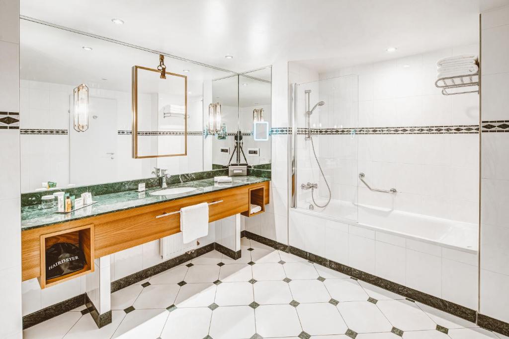 a bathroom with a tub and a sink and a shower at Hilton Imperial Dubrovnik in Dubrovnik