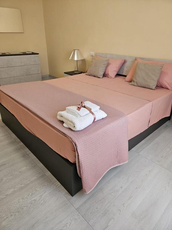 a large bed with two towels on top of it at Royal House Reggia in Caserta