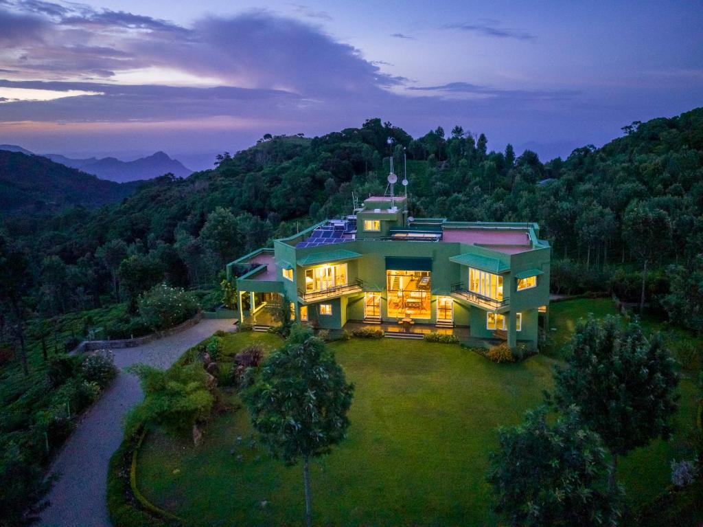 an aerial view of a large house in the mountains at ama Stays & Trails Anjanagiri , Kotagiri in Kotagiri