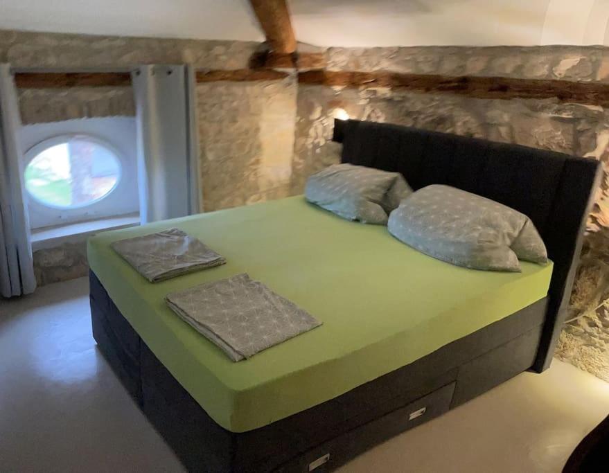 łóżko z dwiema poduszkami w pokoju w obiekcie Villa Makale w mieście Umag