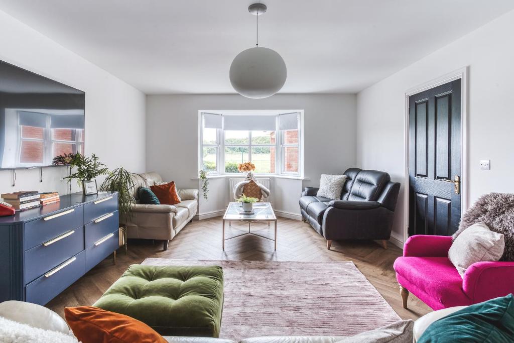 a living room with two couches and a table at Urban Retreat with Park Views in Derby