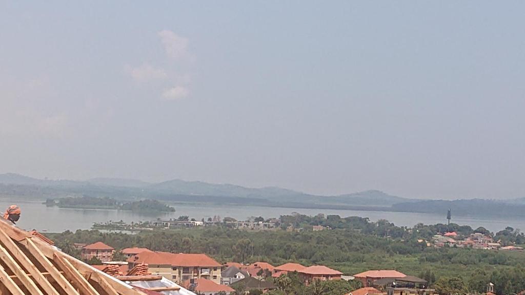 a view of a town and a lake from a roof at Lajungle Muyenga in Kampala