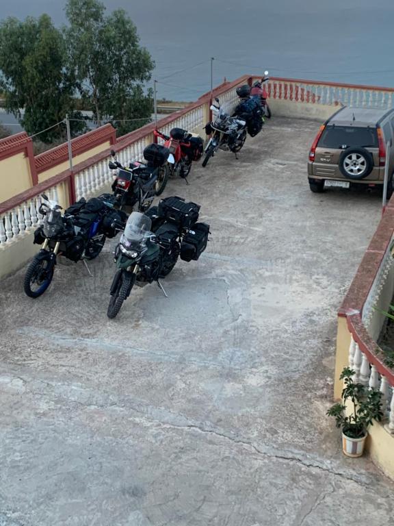 a group of motorcycles parked in a parking lot at Casa Dina in Tangier