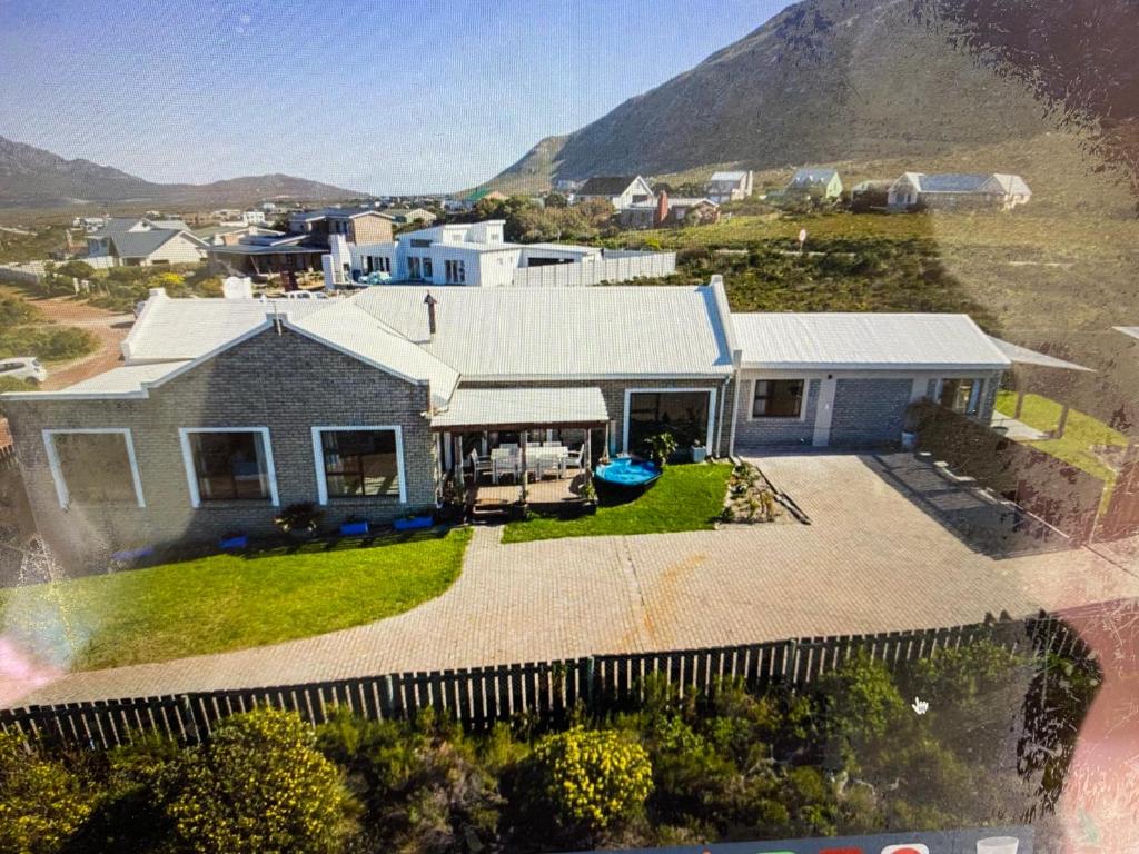 an aerial view of a house with mountains in the background at Sunrise Bettys Bay in Bettyʼs Bay