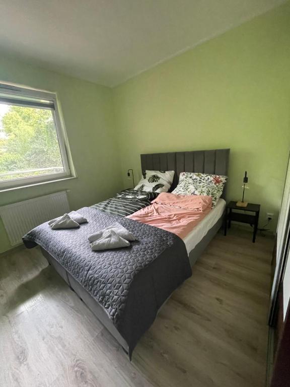 a bedroom with a bed with two towels on it at Apartament Wincentego in Bydgoszcz