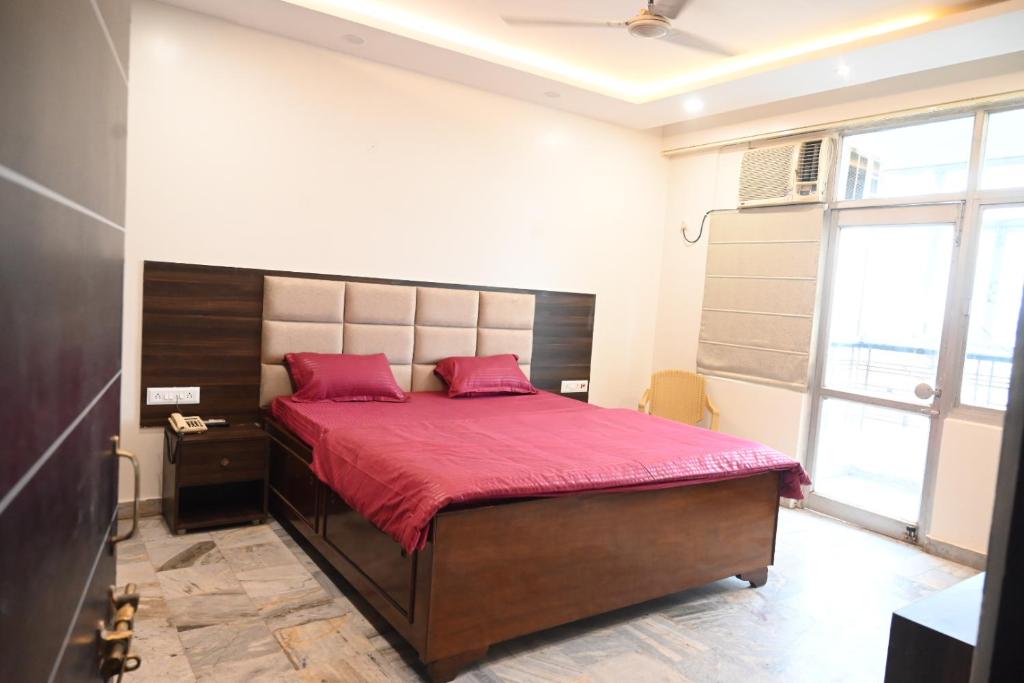 a bedroom with a large bed with a red blanket at Narayan Palace- Luxury Homestay in Varanasi