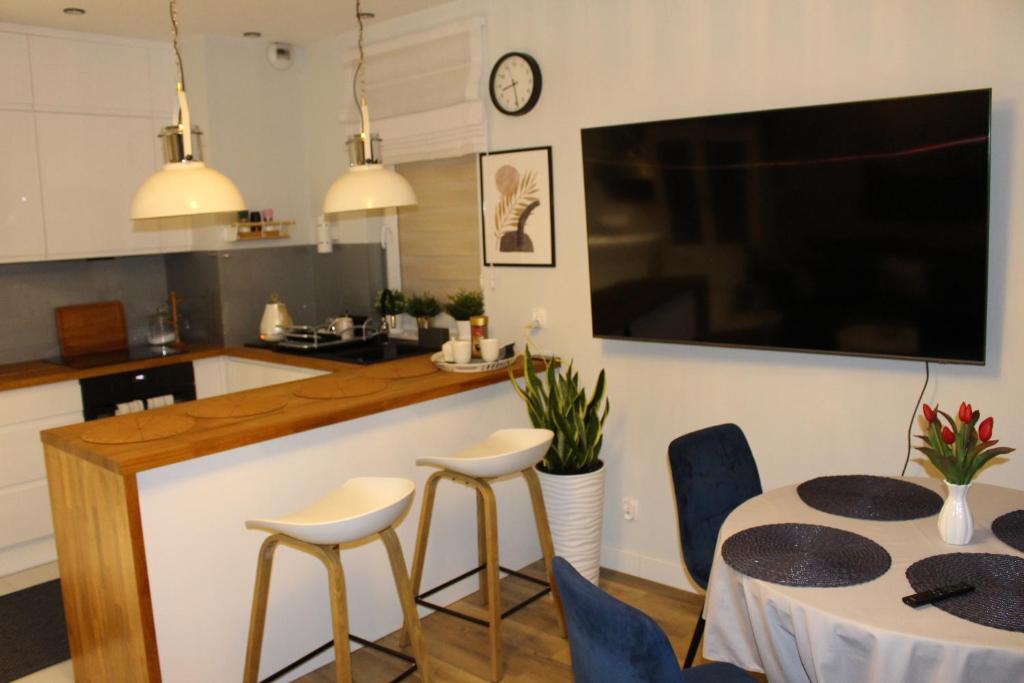 a kitchen and dining room with a table and chairs at Apartament Euro 2 Kraków in Krakow