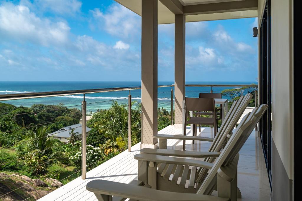 a balcony with chairs and a view of the ocean at East Horizon Self Catering in Au Cap