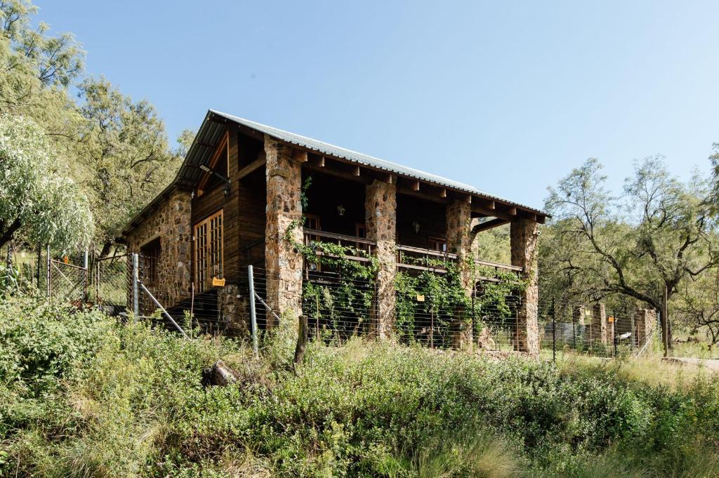 an old barn in the middle of a field at Stone cottage in Haarties in Kalkheuvel