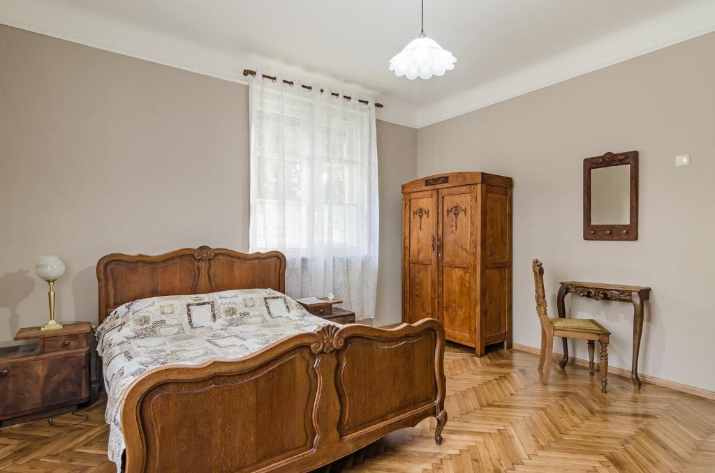 a bedroom with a bed and a dresser and a chair at Апартамент Жасмин in Varna City