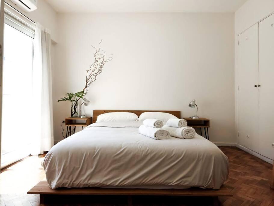 a bedroom with a large bed with towels on it at Palermo Soho Night Life - Alkyl_House in Buenos Aires