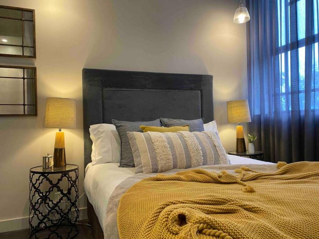 a bedroom with a large bed with two lamps at New York on Moorabool - Free Wi-Fi in Geelong
