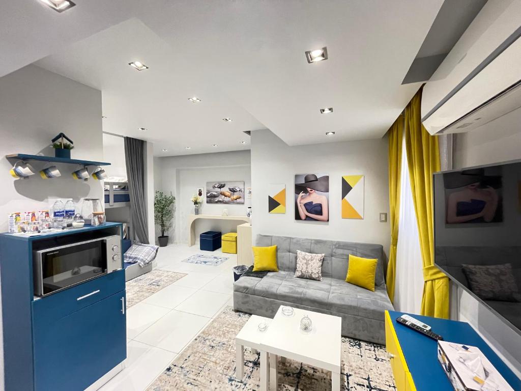 a living room with a couch and a tv at Luxury Studio House 589-5 in 6th Of October