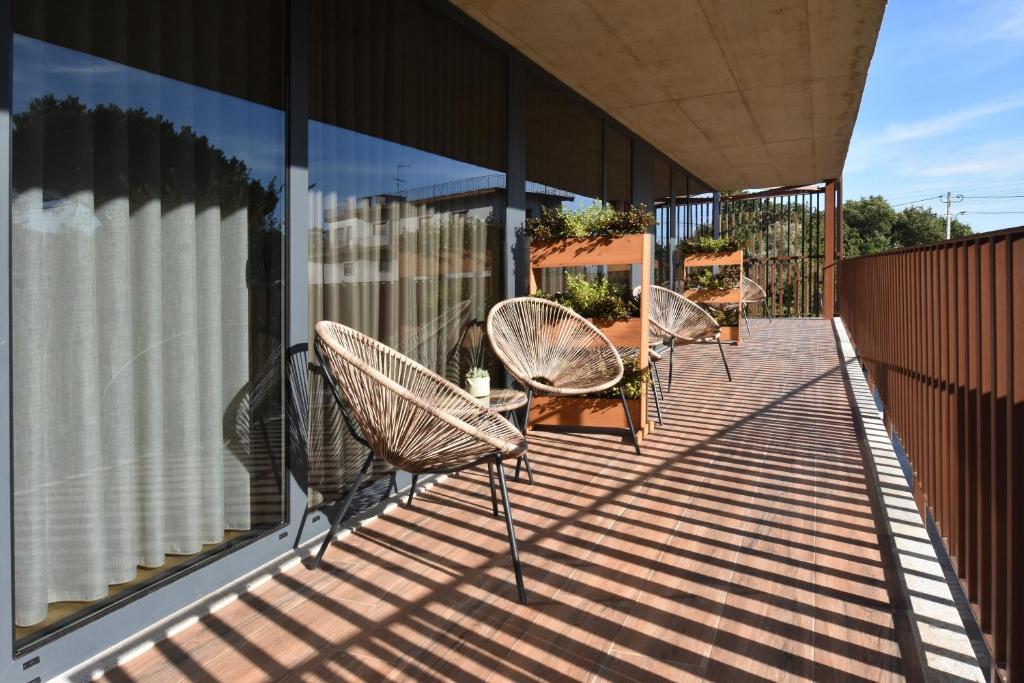 a group of chairs sitting on a balcony at Alminhas da Mindua in Vitorino dos Piães