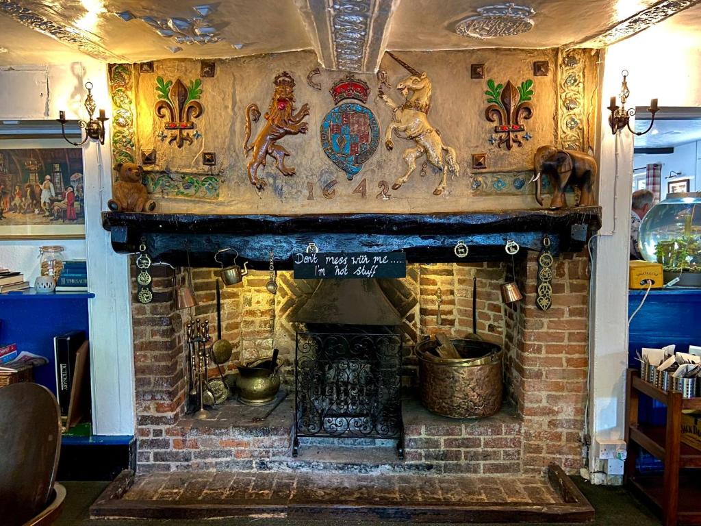 a brick fireplace in a room with at The King's Lodge Hotel in Kings Langley