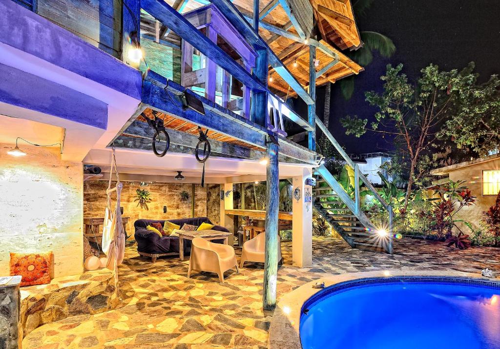 a house with a swimming pool at night at Cabarete Boutique Kite Hotel King Loft in Cabarete