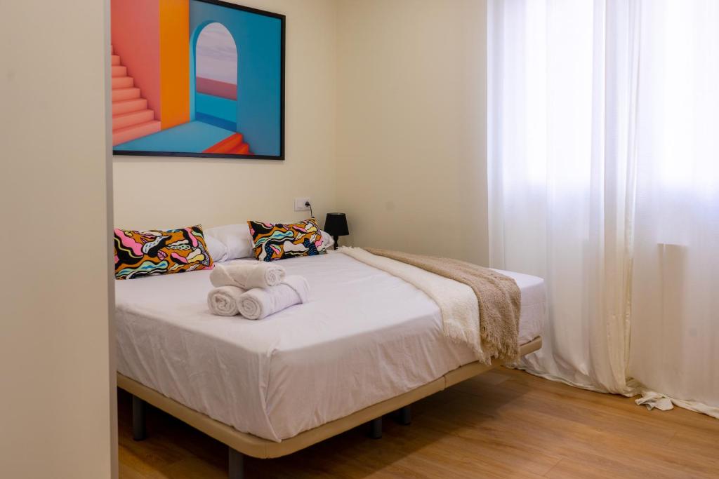 a bedroom with a bed with towels on it at BILBAO NORTH SHORE APARTMENTS in Bilbao
