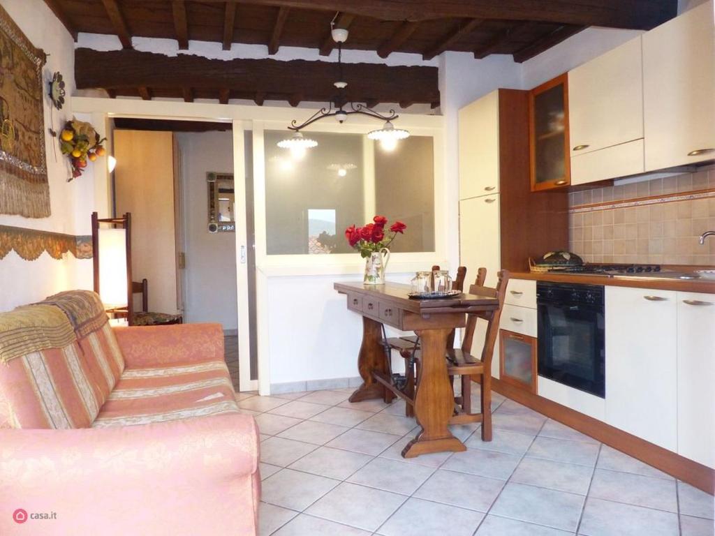 a kitchen with a table and a couch in a room at Casa Marciana 2 - Isola D'Elba in Marciana